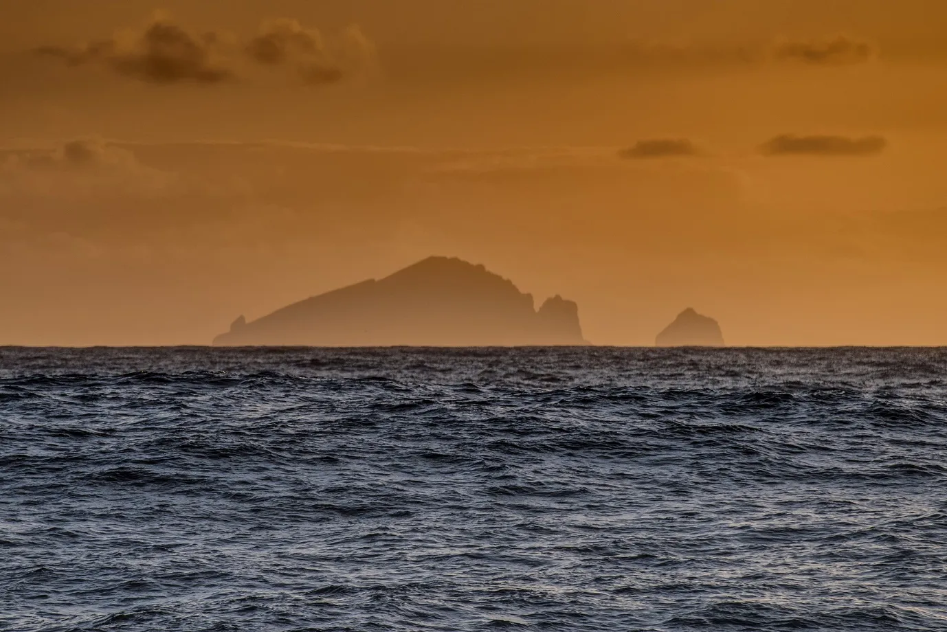 The islands of St Kilda silhouetted on the horizon at sunset